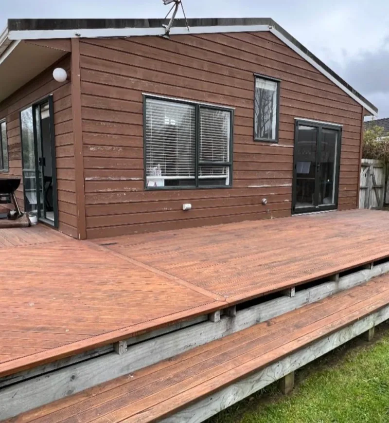 Brown weatherboard exterior and deck before painting.