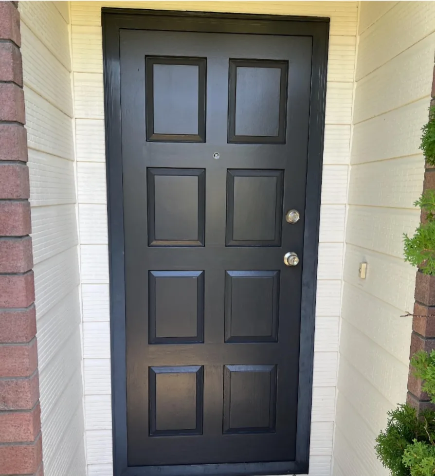 Dark-painted panelled front door.