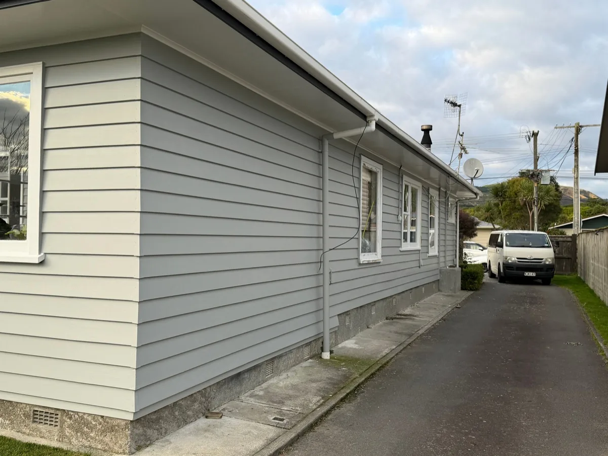 Freshly painted light-coloured weatherboard exterior.